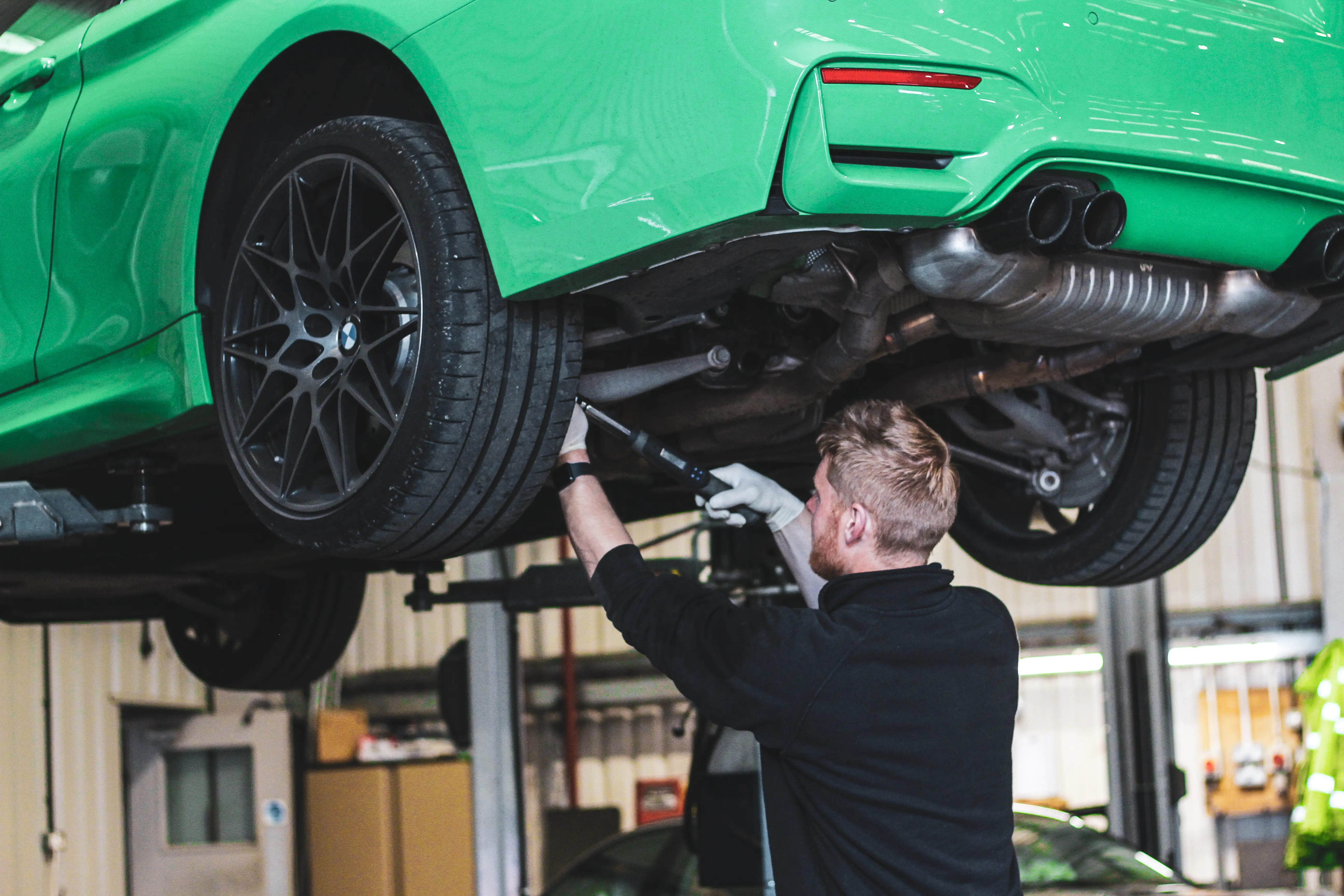 Technician working under a BMW at Dack
